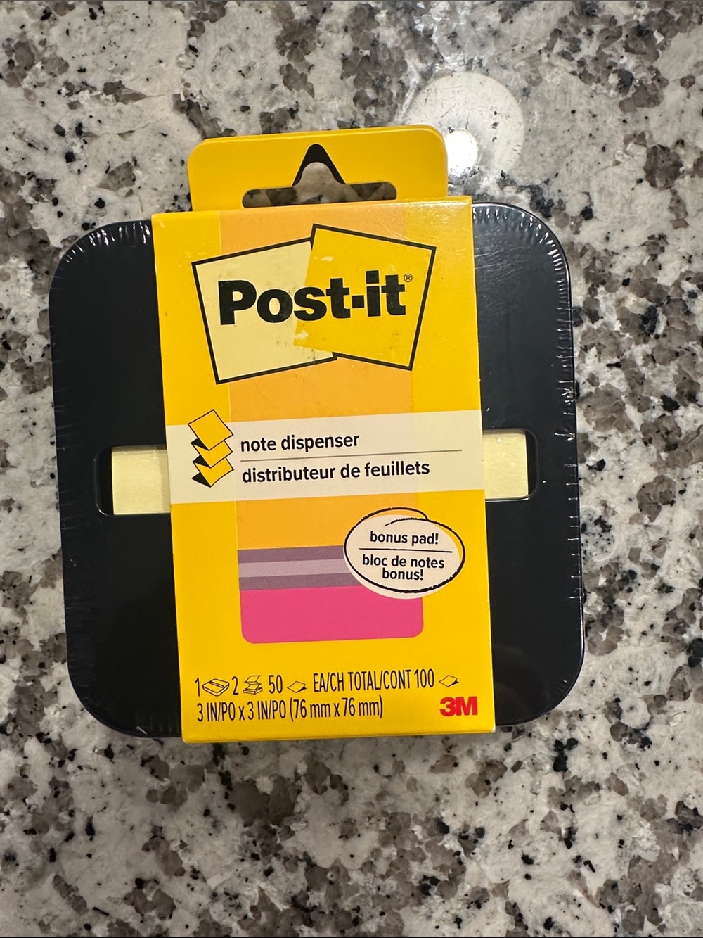 Post-it  note dispenser with a bonus sticky notepad.